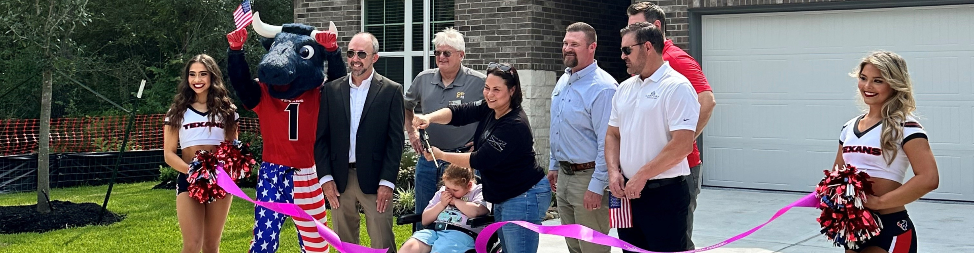 A group of people posing with a person in a garment.