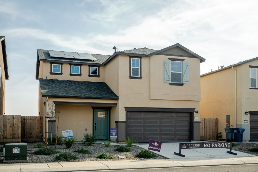 A building with garages and a sign in front of it.