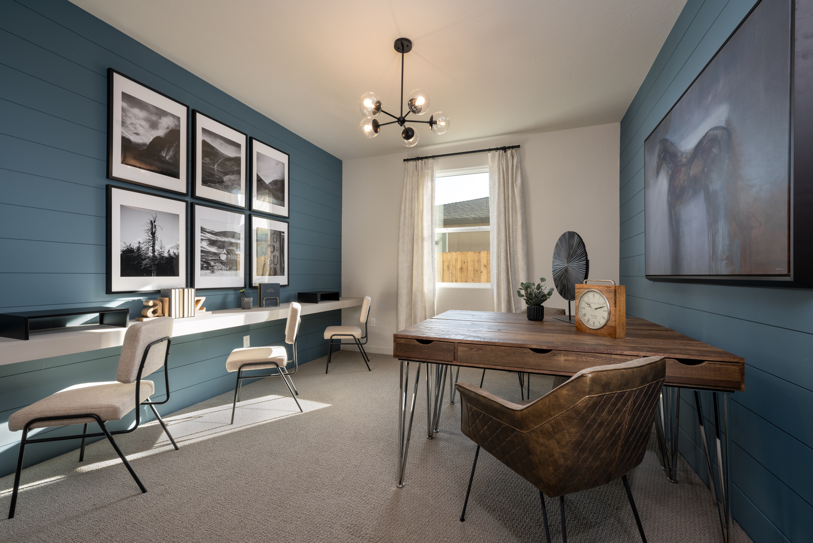 A dining room with a table and chairs.
