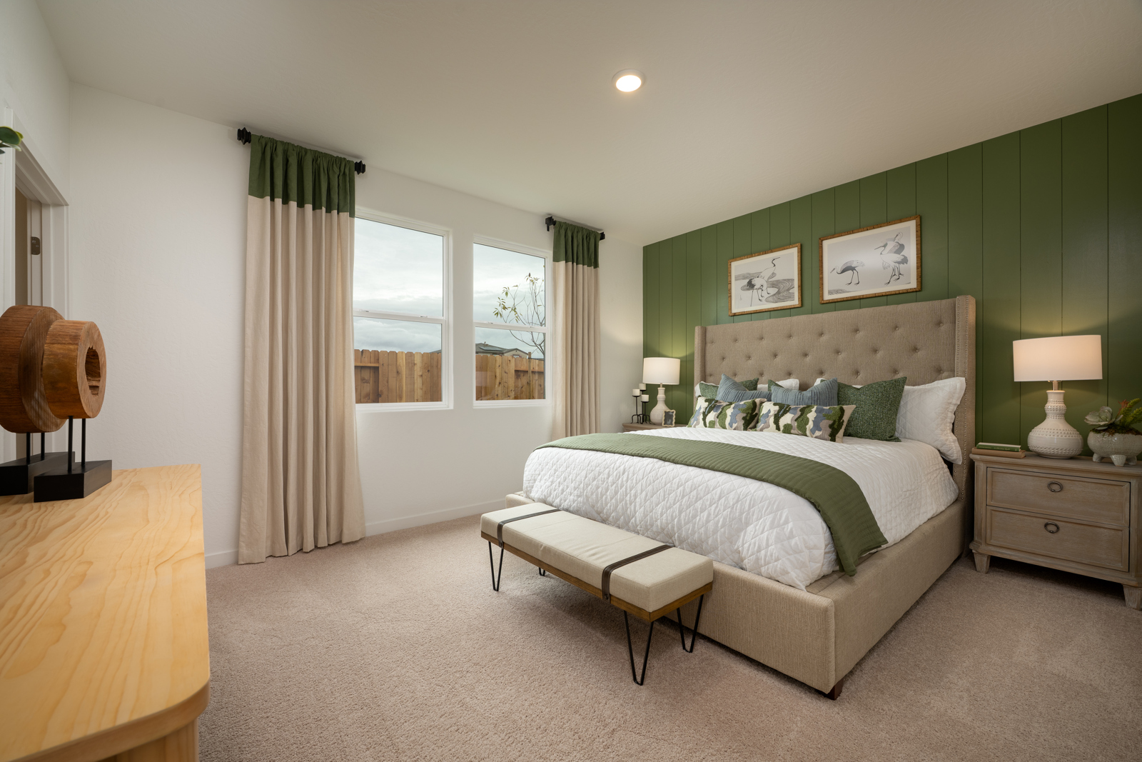 A bedroom with a bed and a bench.