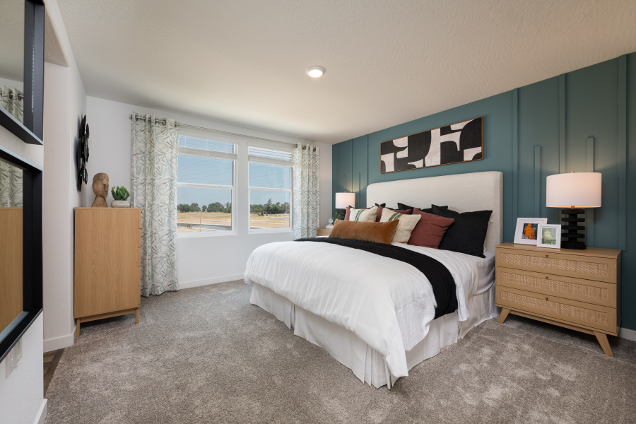 A bedroom with a bed and a window.