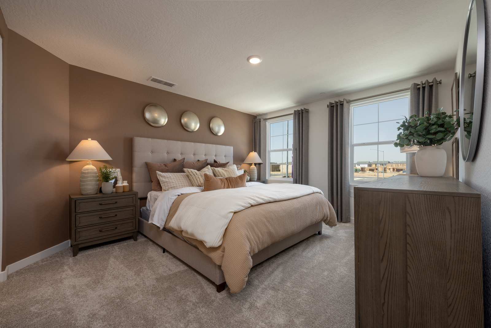 A bedroom with a bed and lamps.