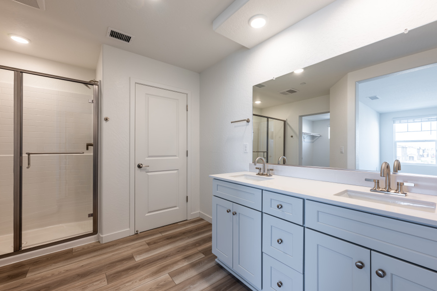 A bathroom with white cabinets.