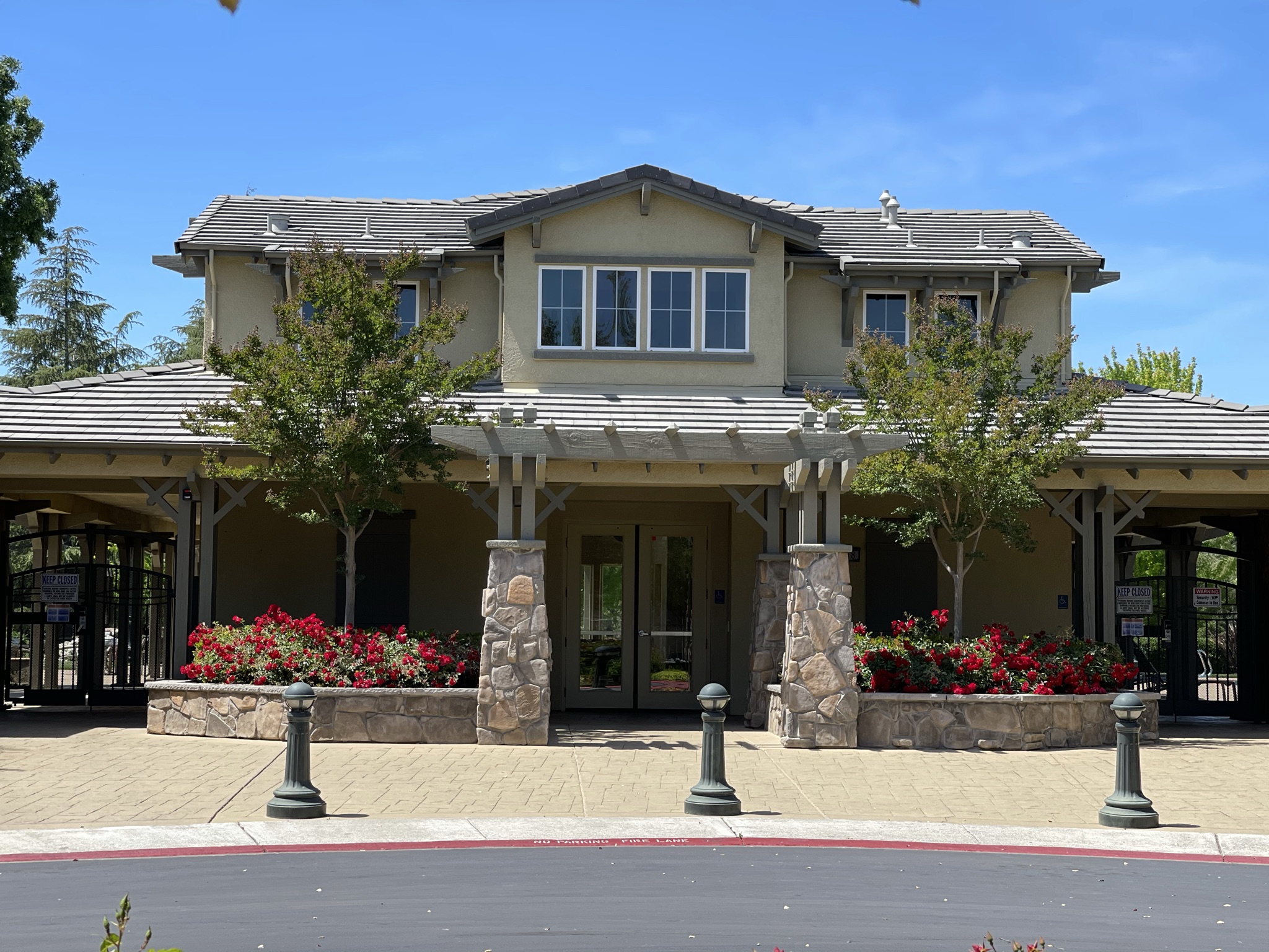 A house with a gate and trees.