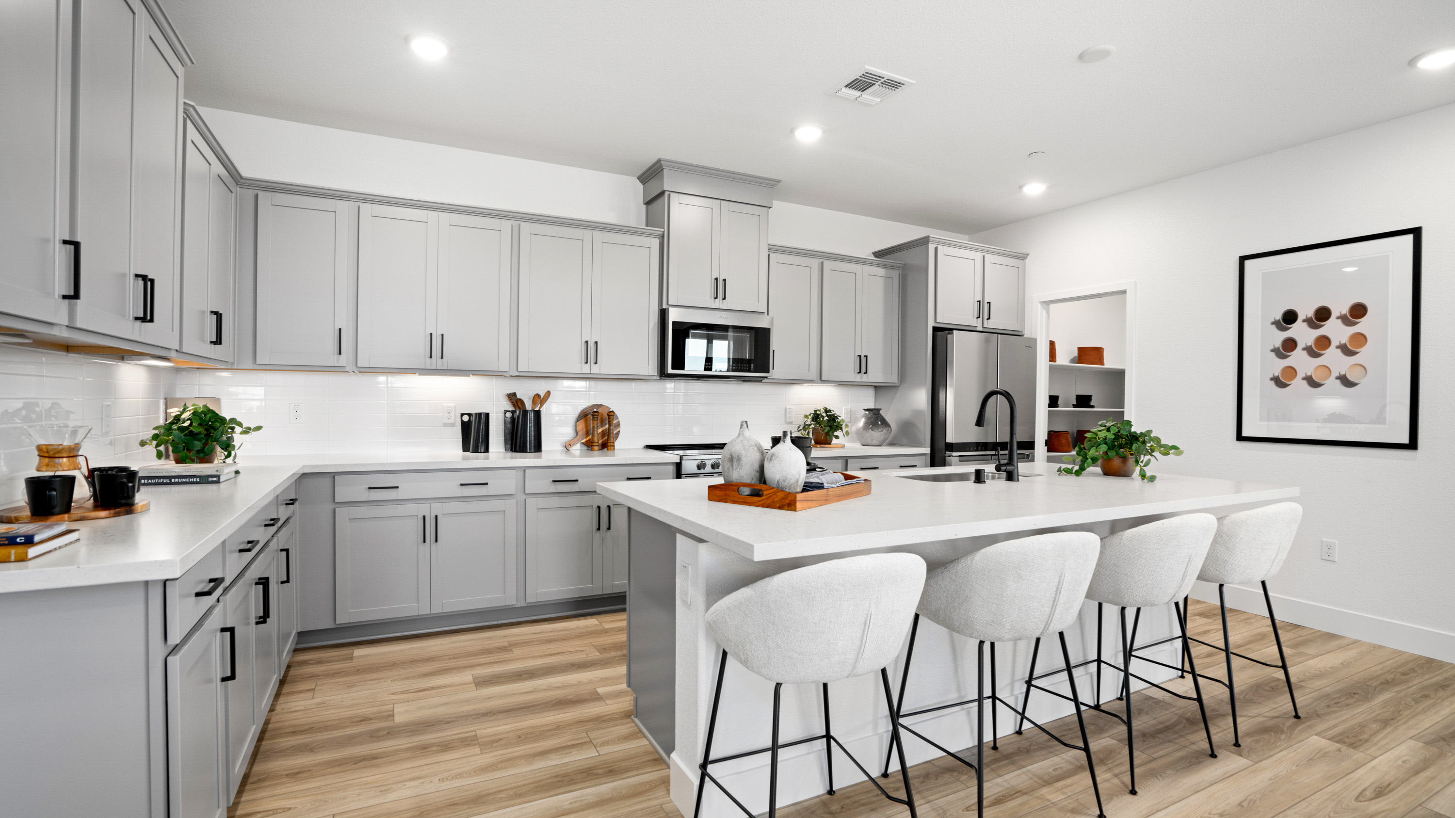 A kitchen with white cabinets.
