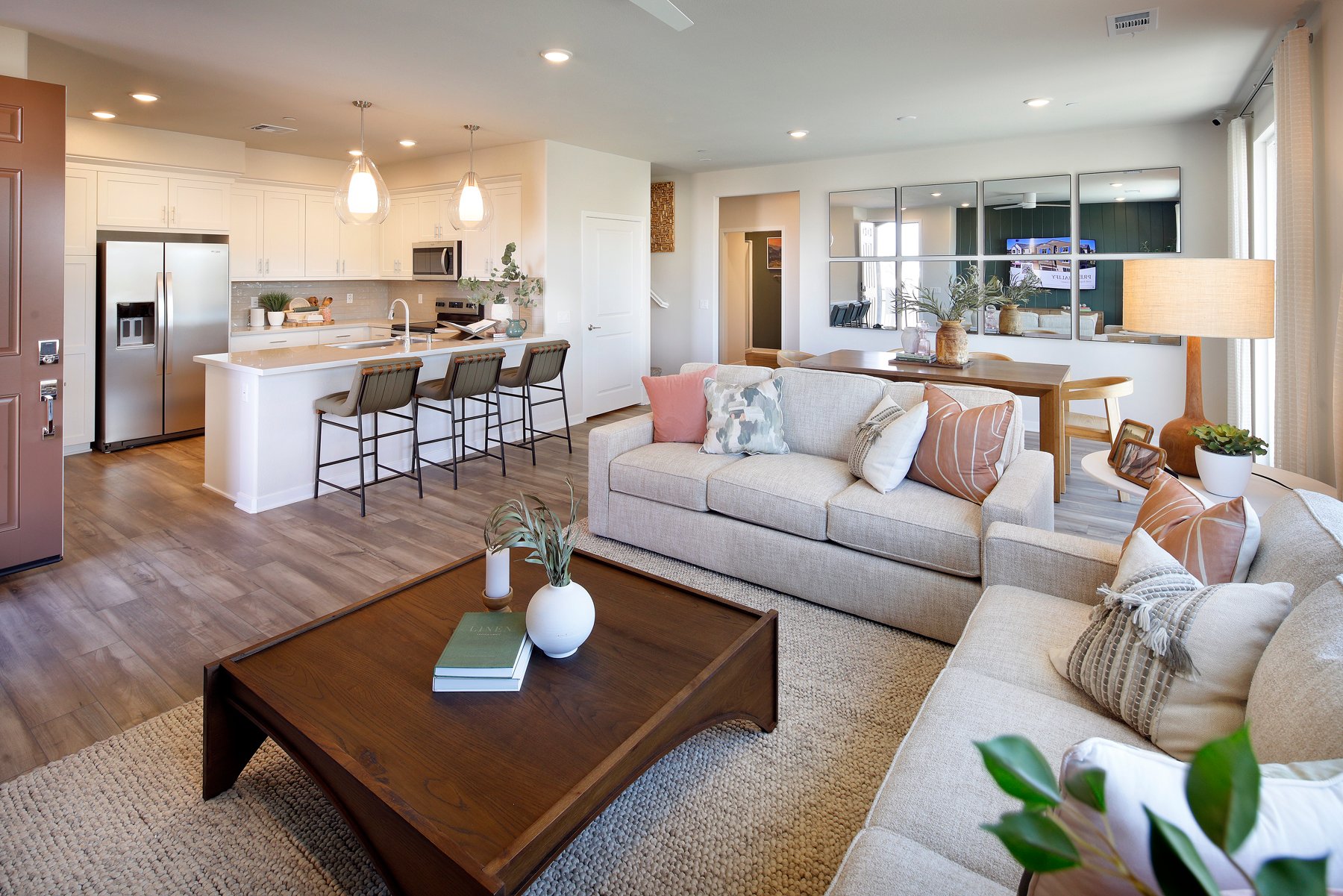 A living room with a large kitchen.