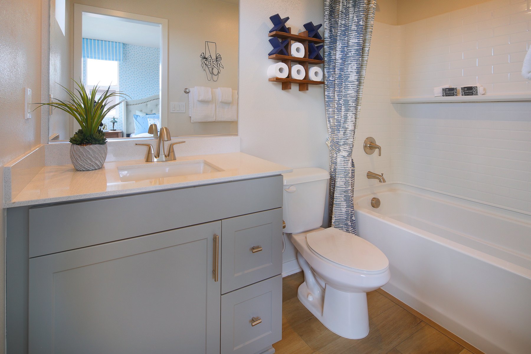 A bathroom with a sink toilet and bathtub.