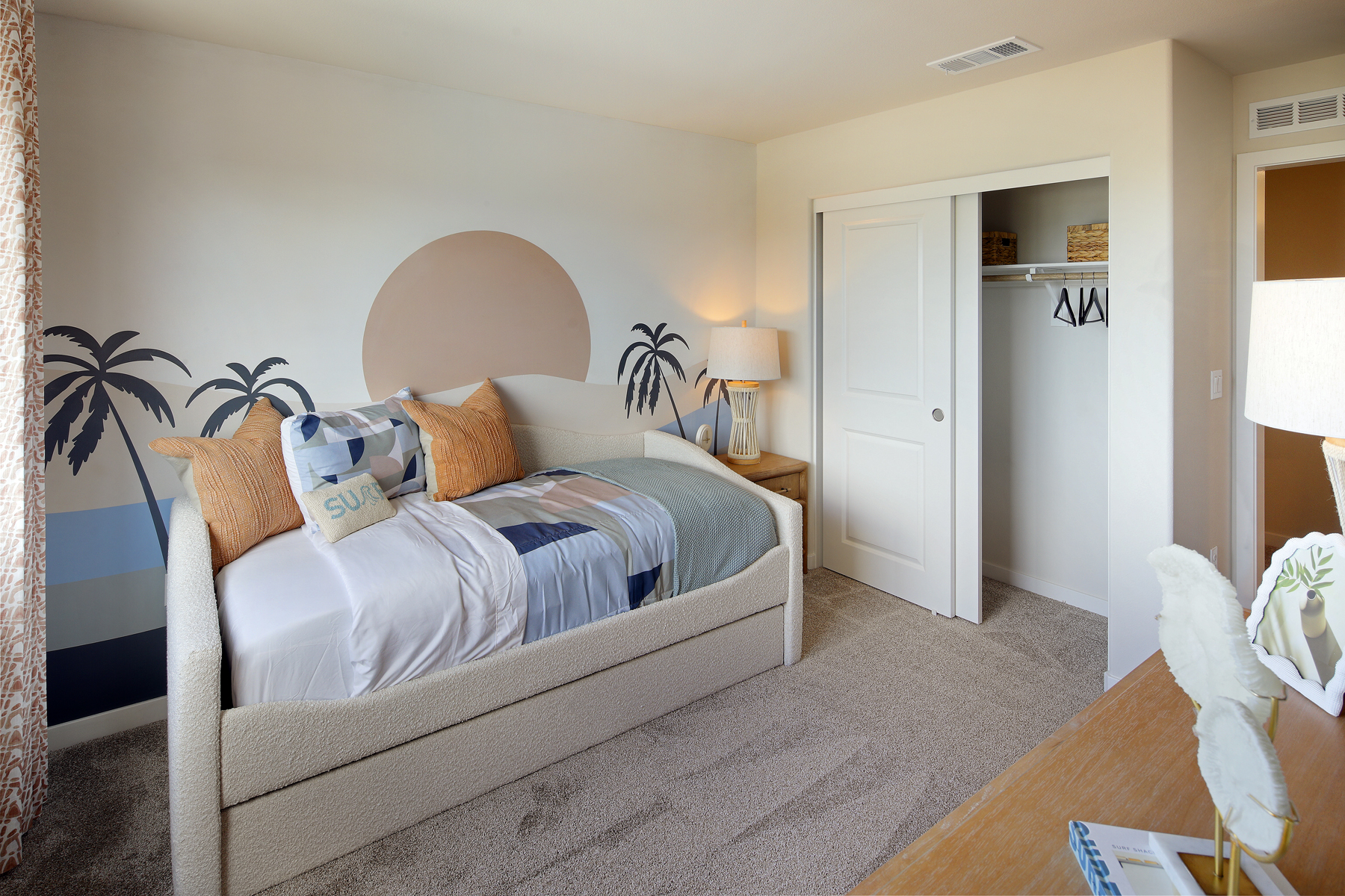 A bedroom with a bed and a lamp.