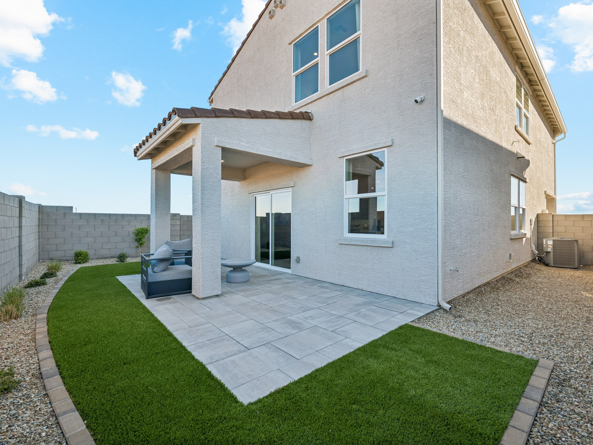 A house with a stone patio.