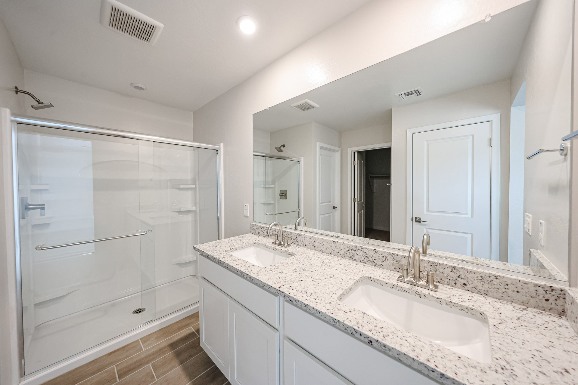A bathroom with a large mirror.
