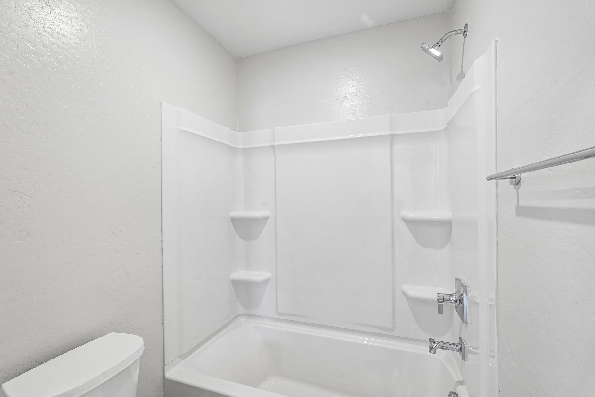 A bathroom with a tub toilet and sink.