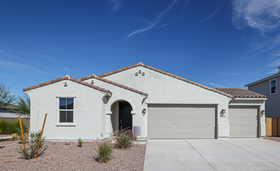 A house with garages and a blue sky.