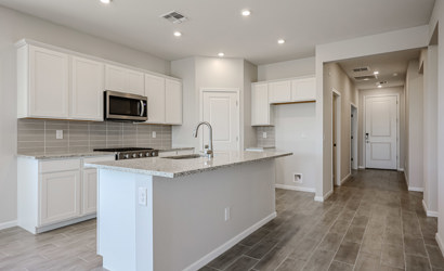 A kitchen with white cabinets.