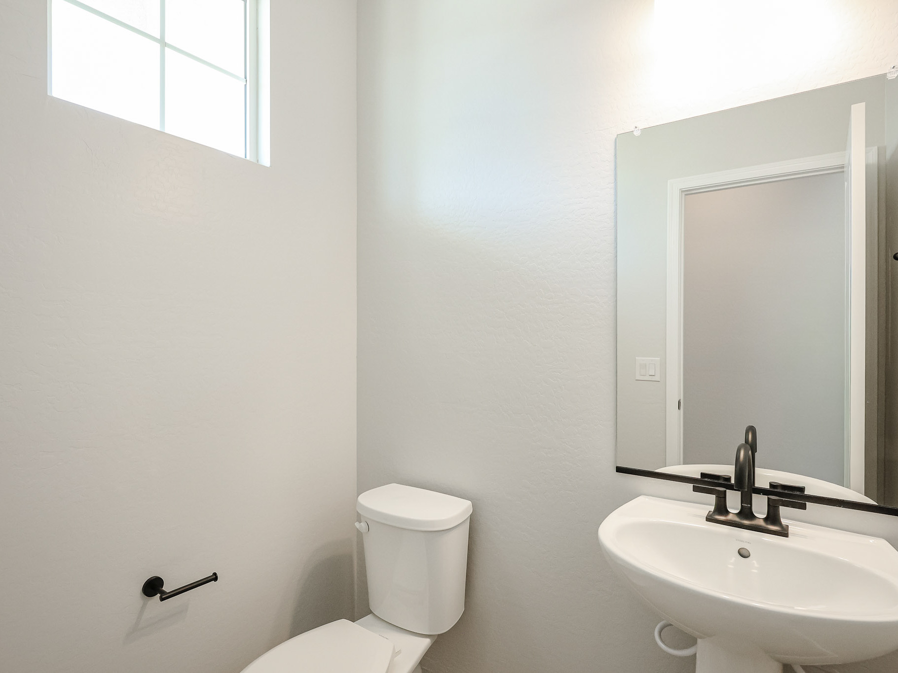 A bathroom with a toilet and sink.