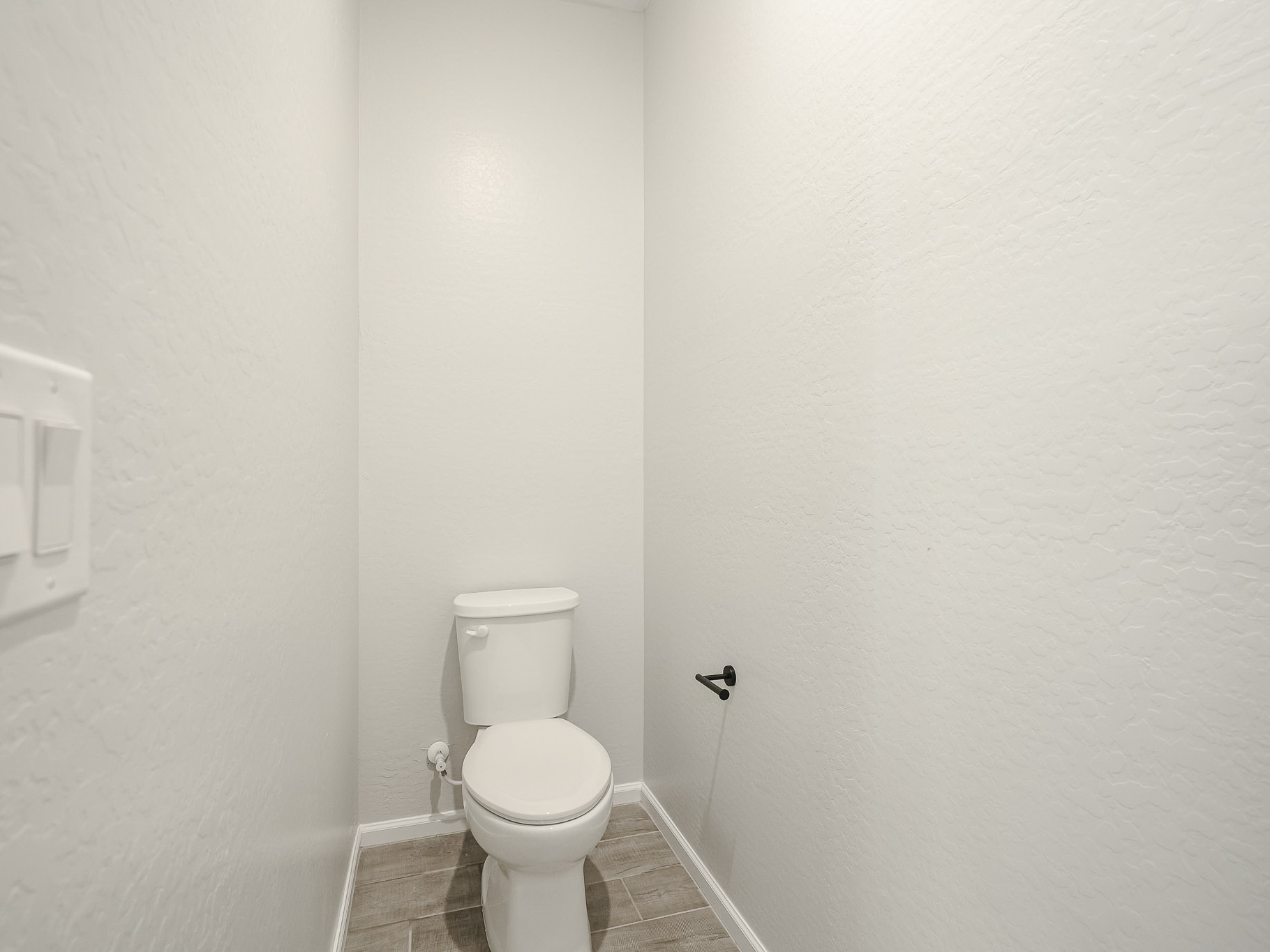 A toilet in a bathroom.