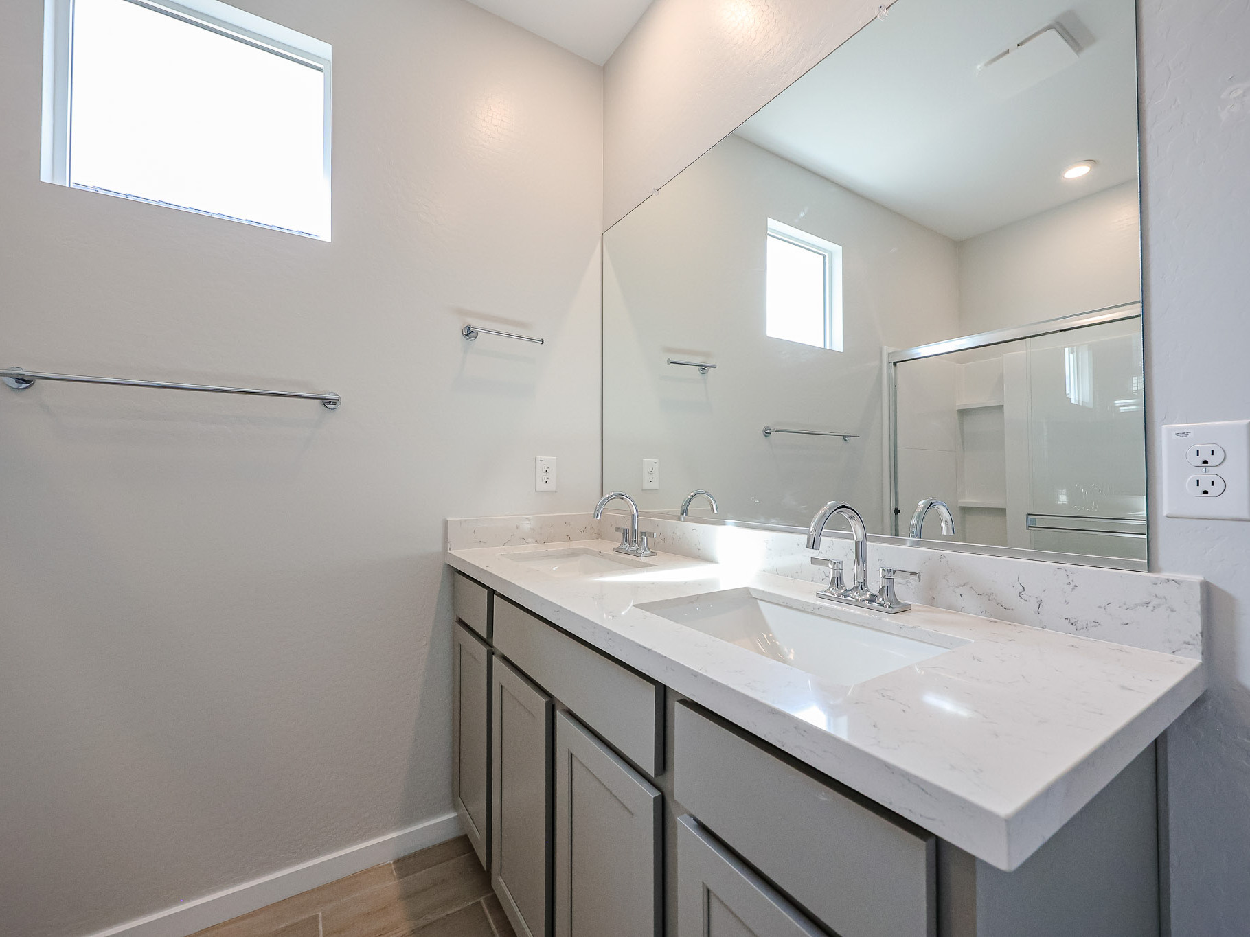 A bathroom with sinks and mirrors.