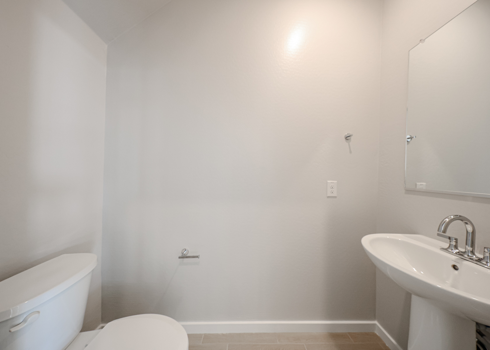 A bathroom with a sink and toilet.
