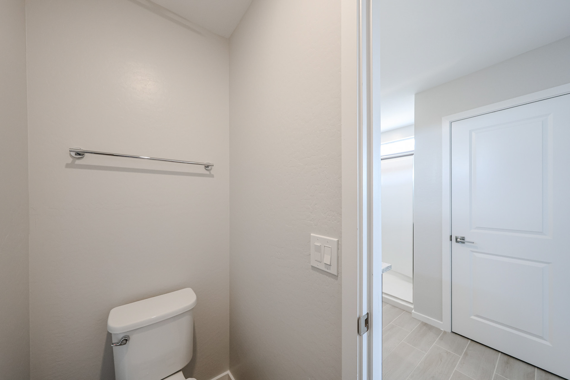 A bathroom with white walls.