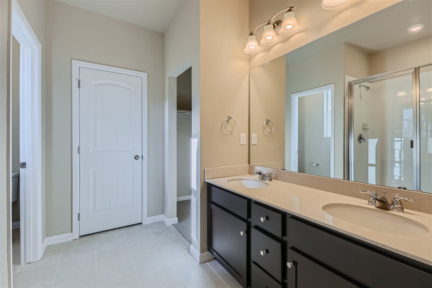 A bathroom with a large mirror.