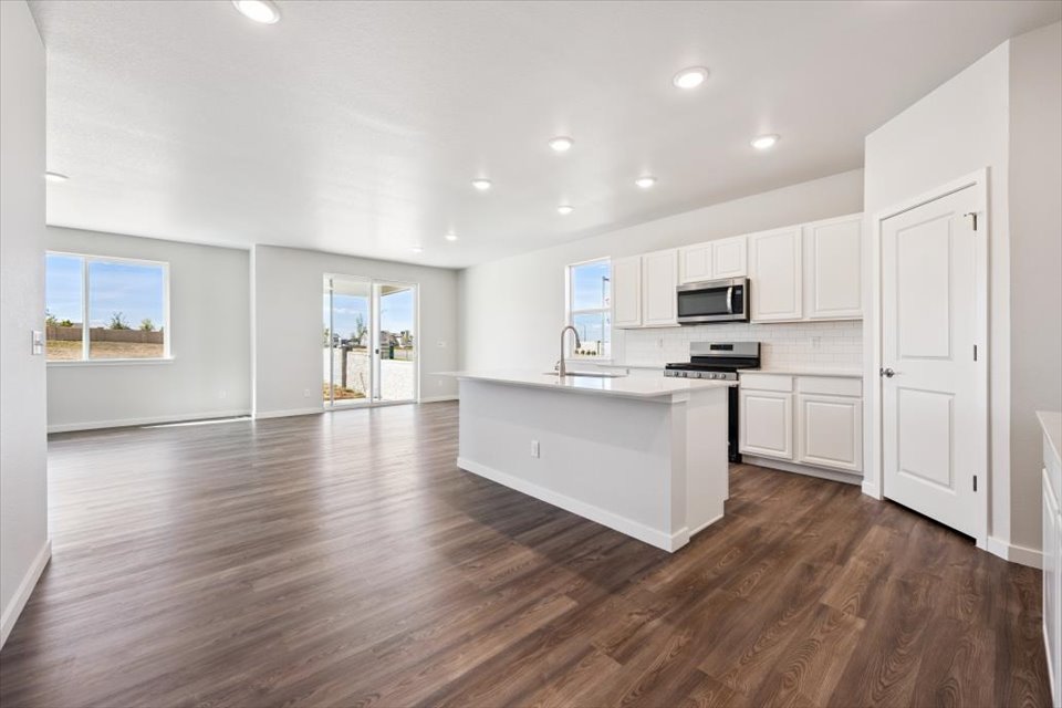 A large kitchen with white cabinets.