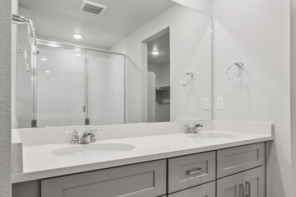A bathroom with a large mirror.