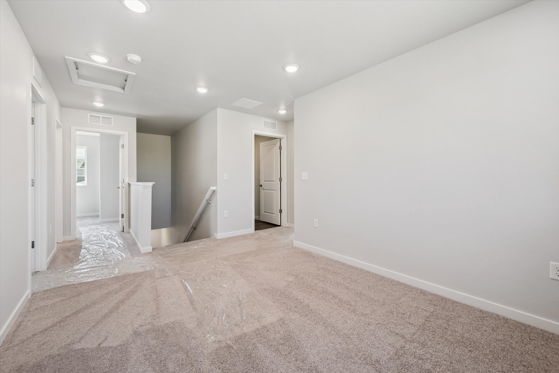 A hallway with white walls.