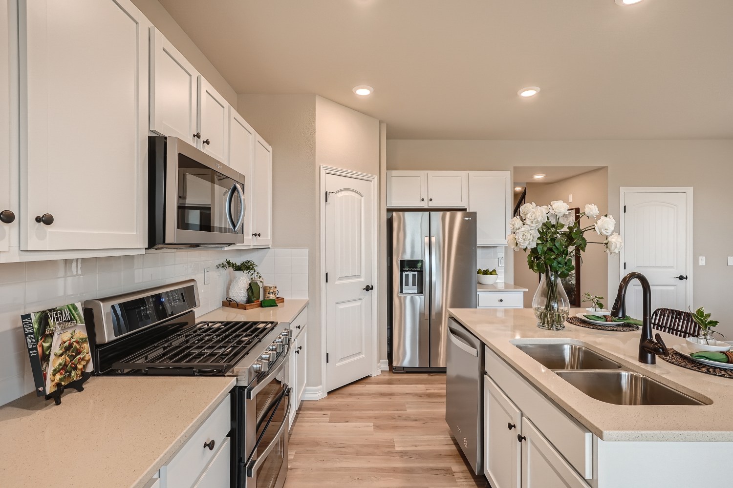 A kitchen with white cabinets.