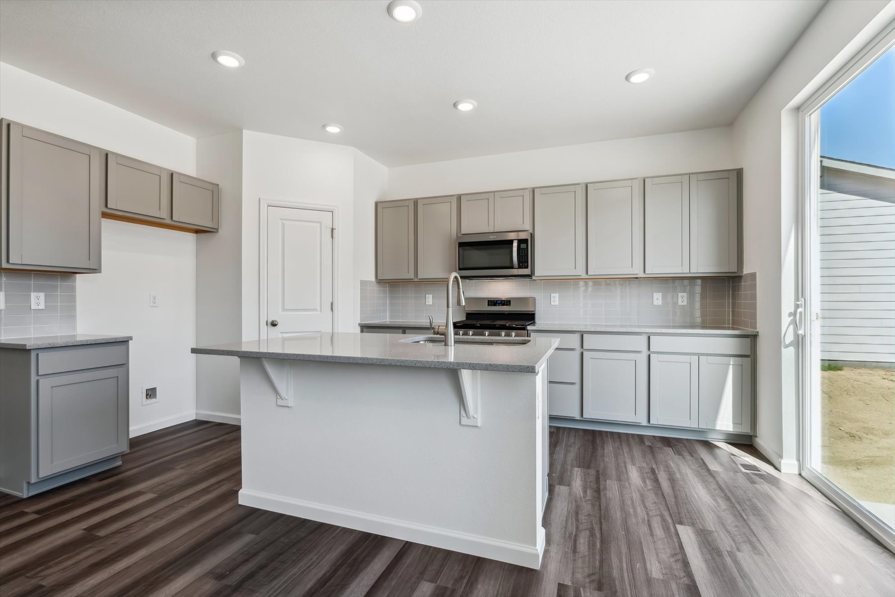 A kitchen with white cabinets.