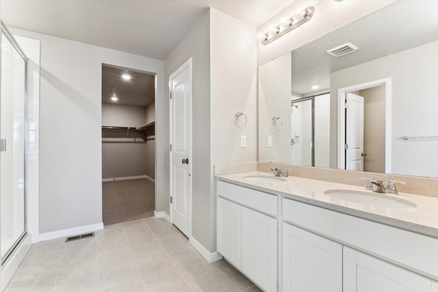 A bathroom with a large mirror.