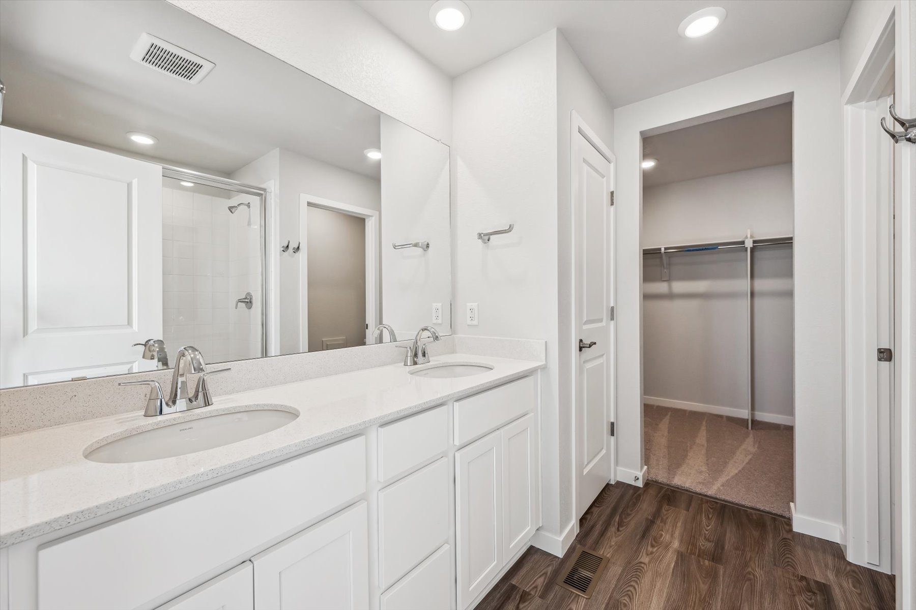 A bathroom with a shower and sink.