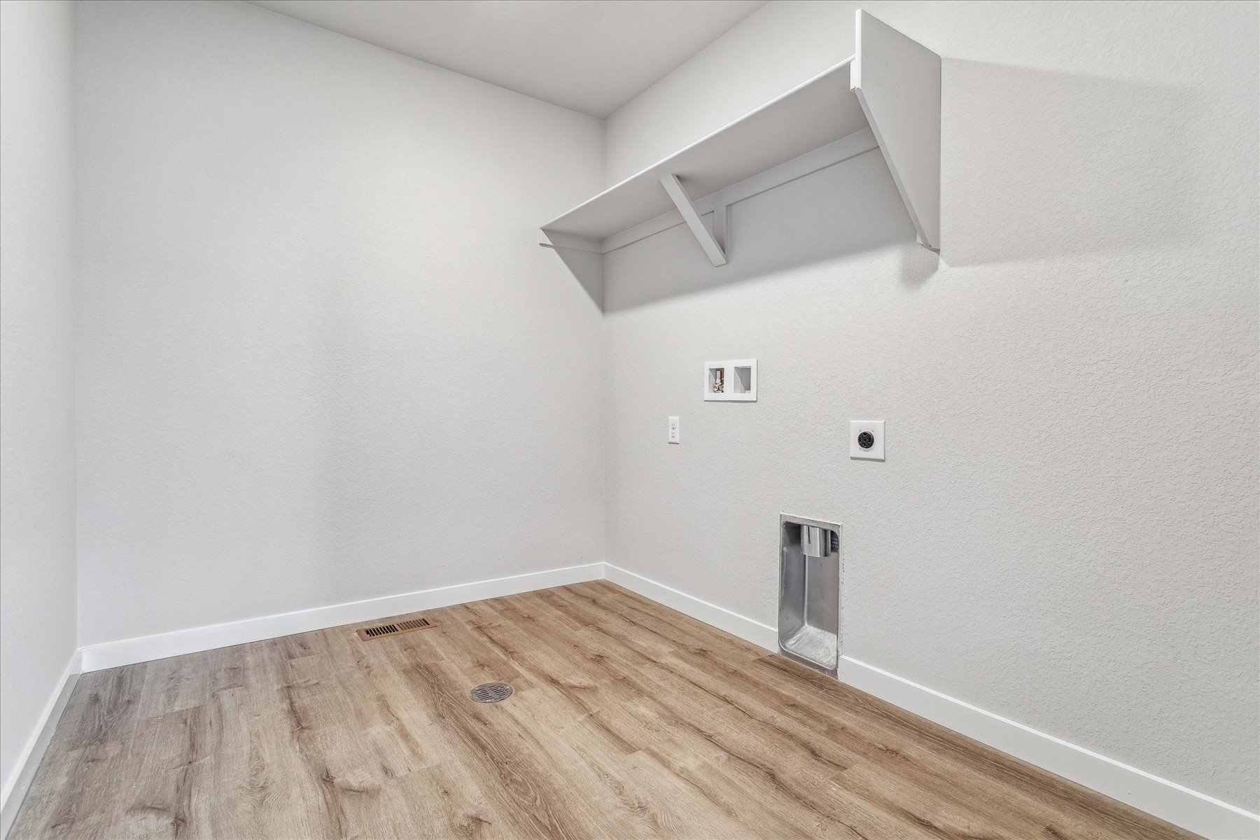 A room with a wood floor and white walls.