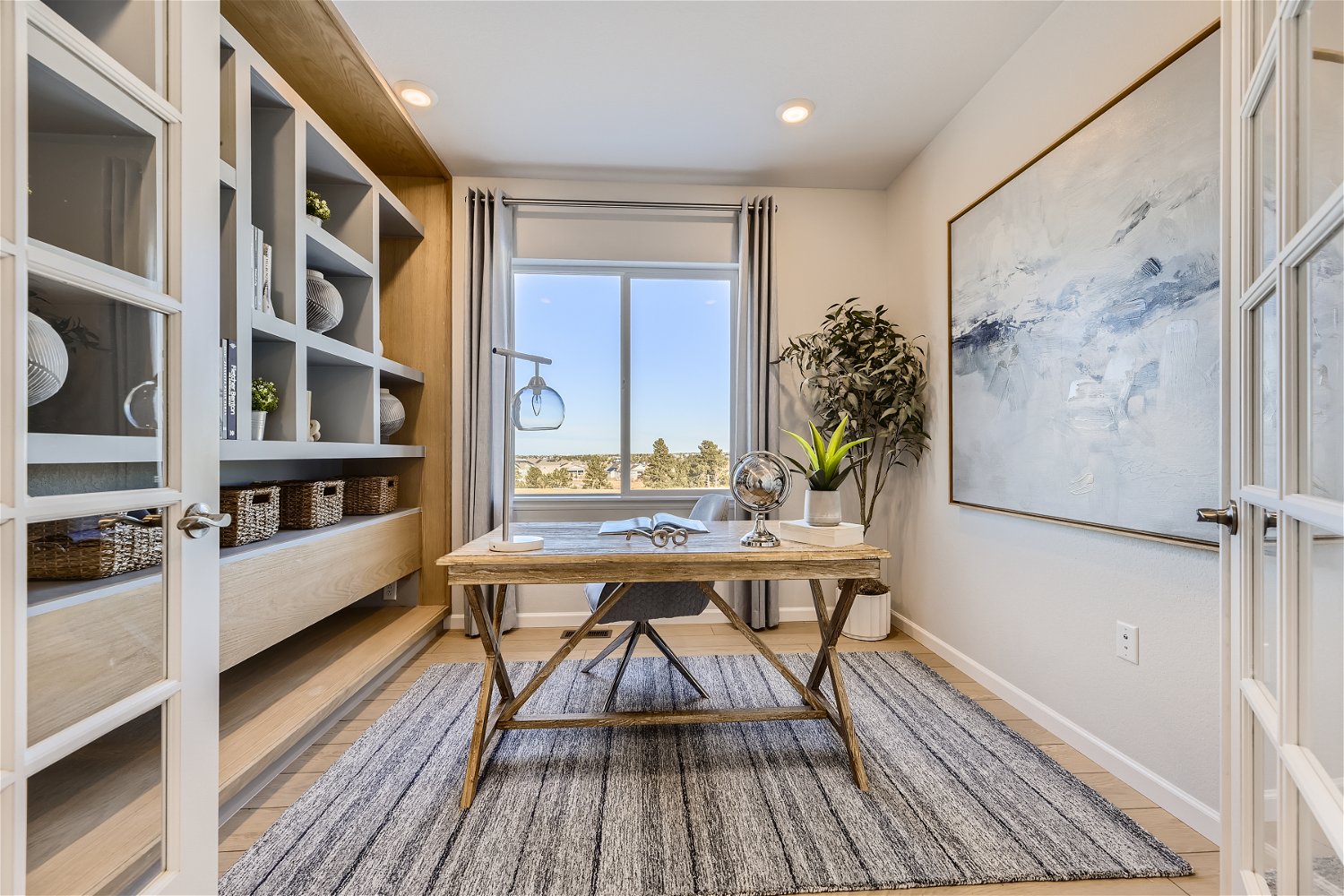 A room with a table and shelves.