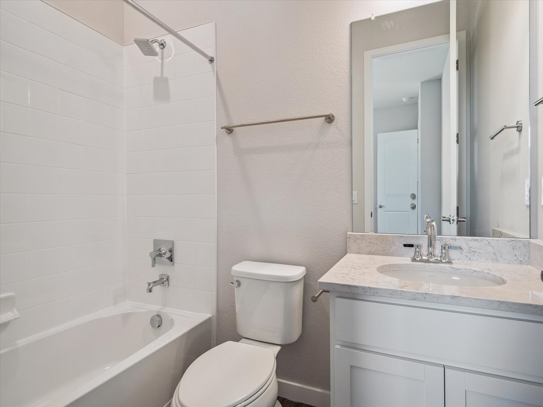 A bathroom with a tub sink and toilet.