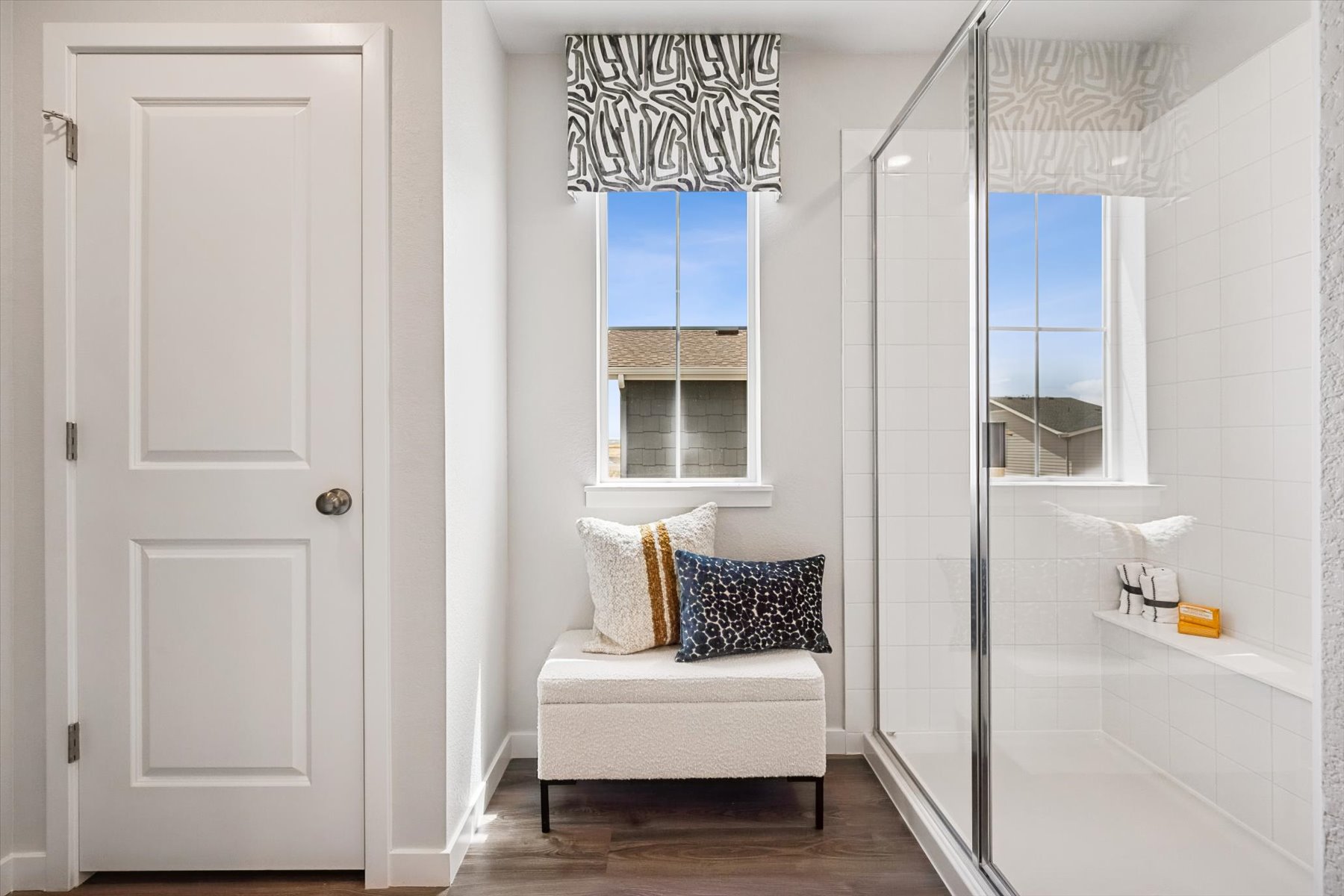 A white bathroom with a glass shower.
