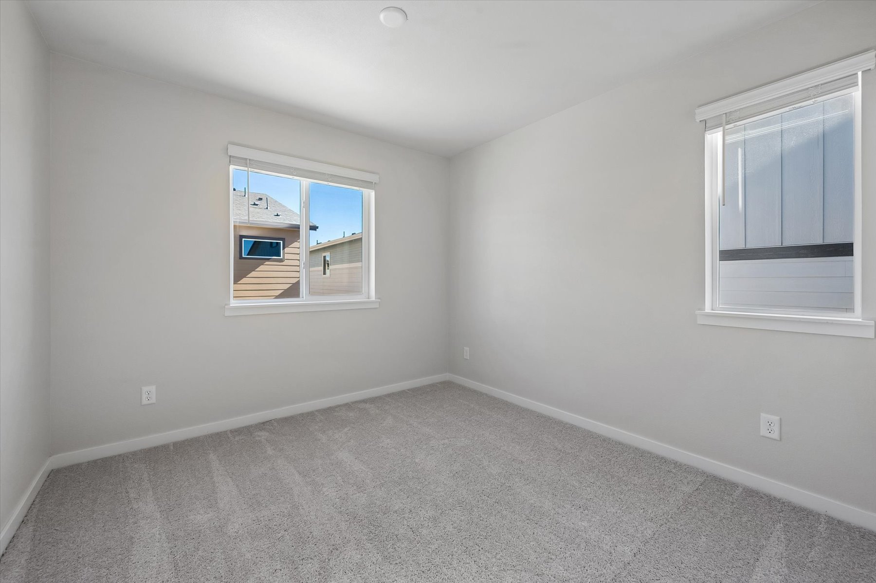 A room with a window and a carpet.
