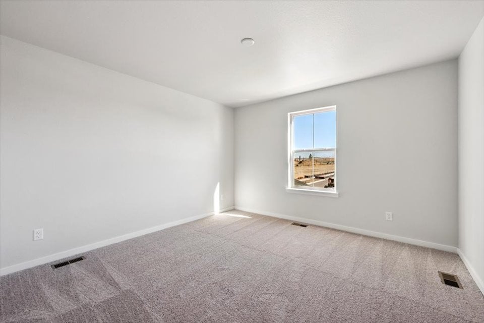 A room with a window and carpet.