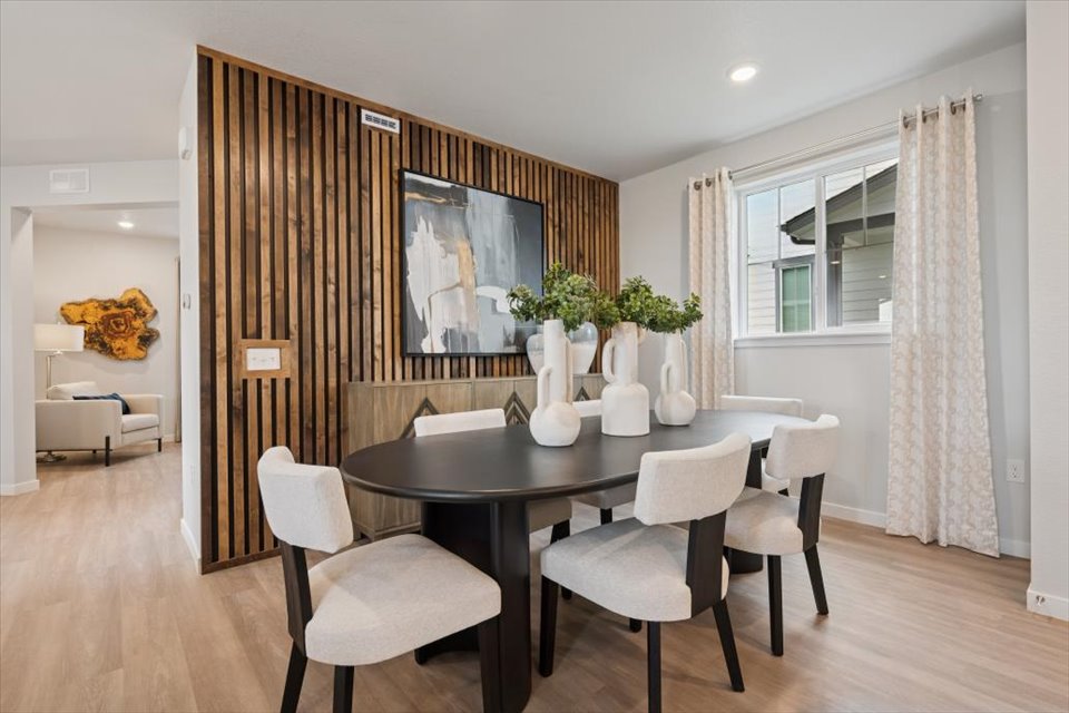 A room with a table and chairs.