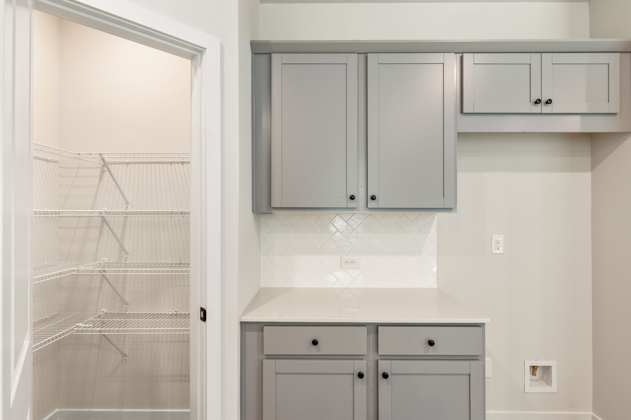 A white kitchen with white cabinets.