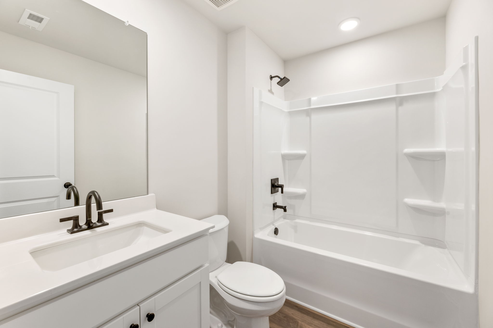 A bathroom with a tub sink and toilet.