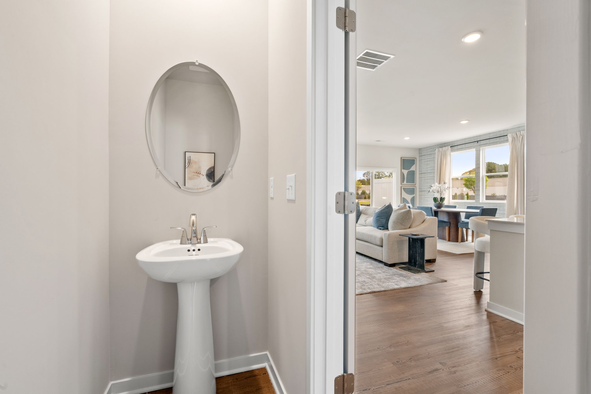 A bathroom with a sink and a bed.