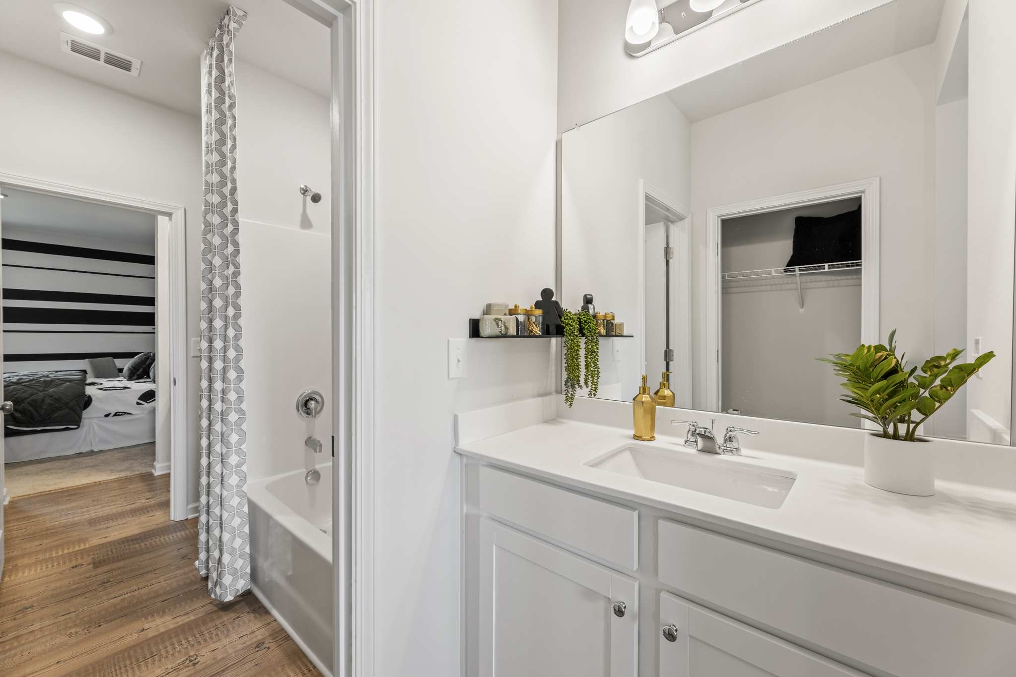 A bathroom with a sink and a shower.