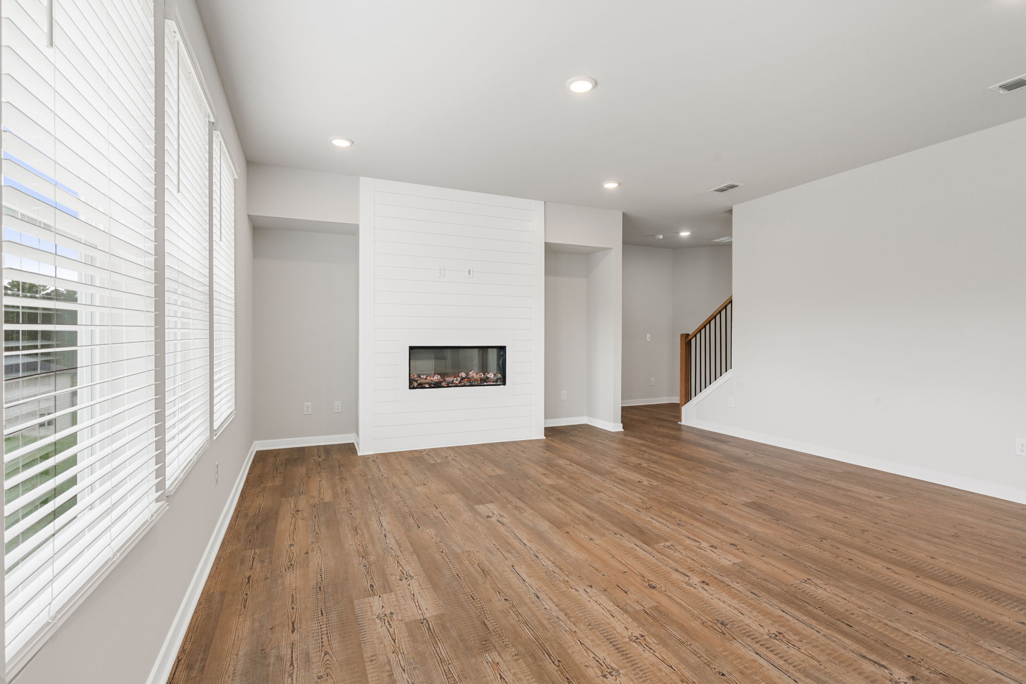 A room with a fireplace and a wood floor.
