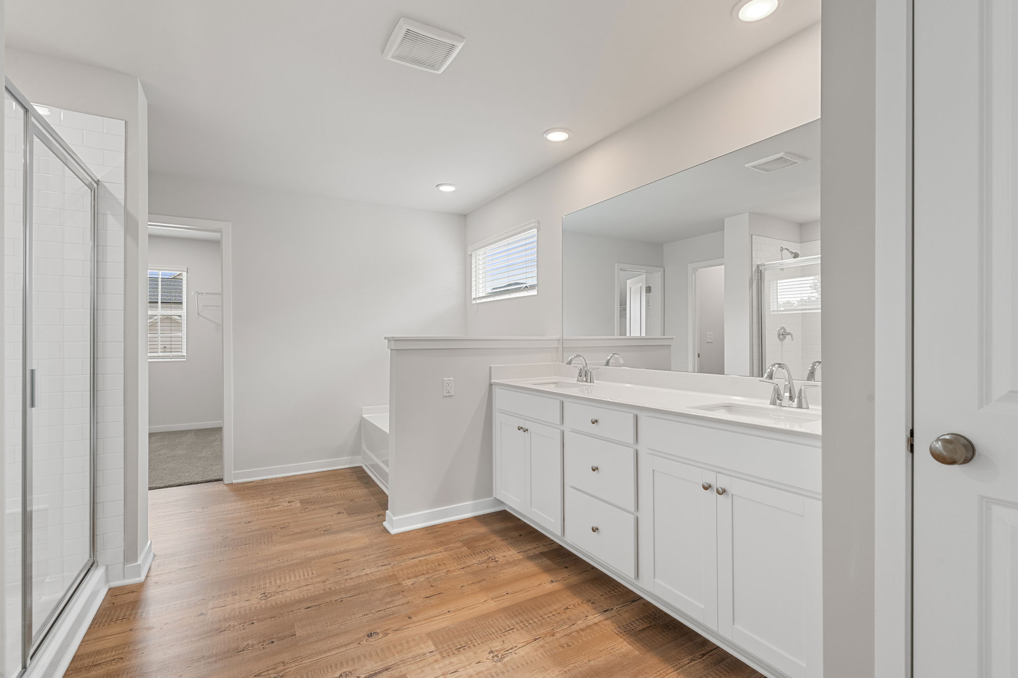 A bathroom with white cabinets.