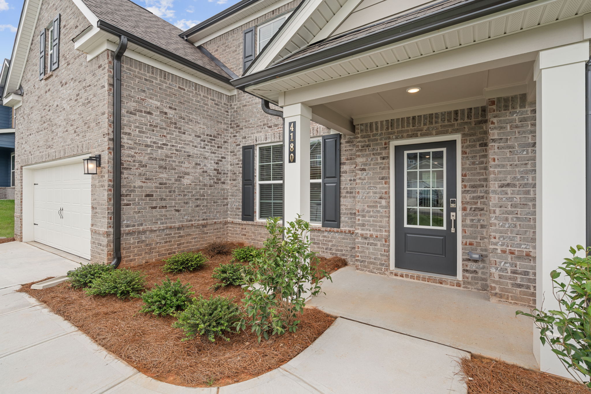 A house with a brick driveway.