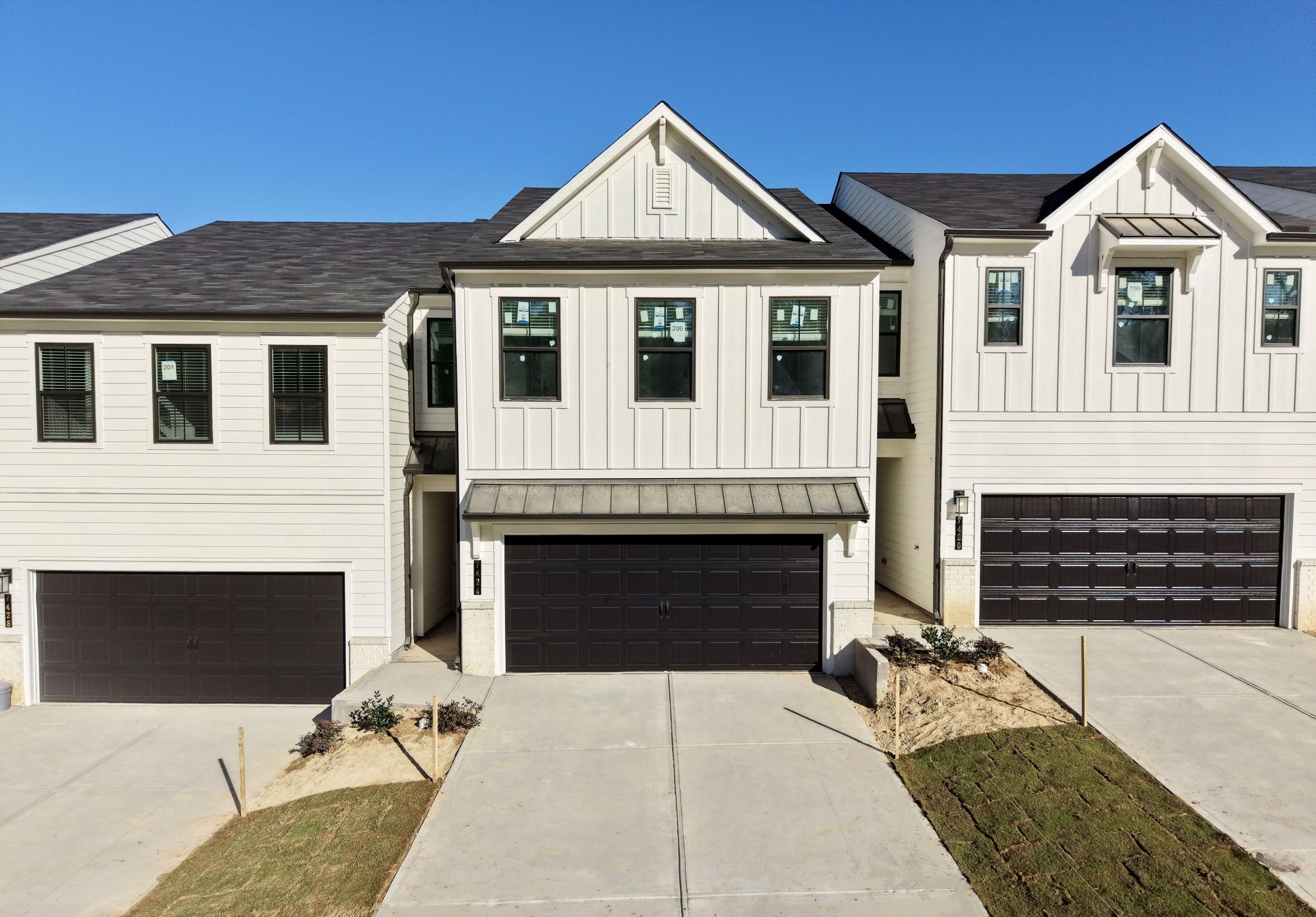 A white house with a garage.