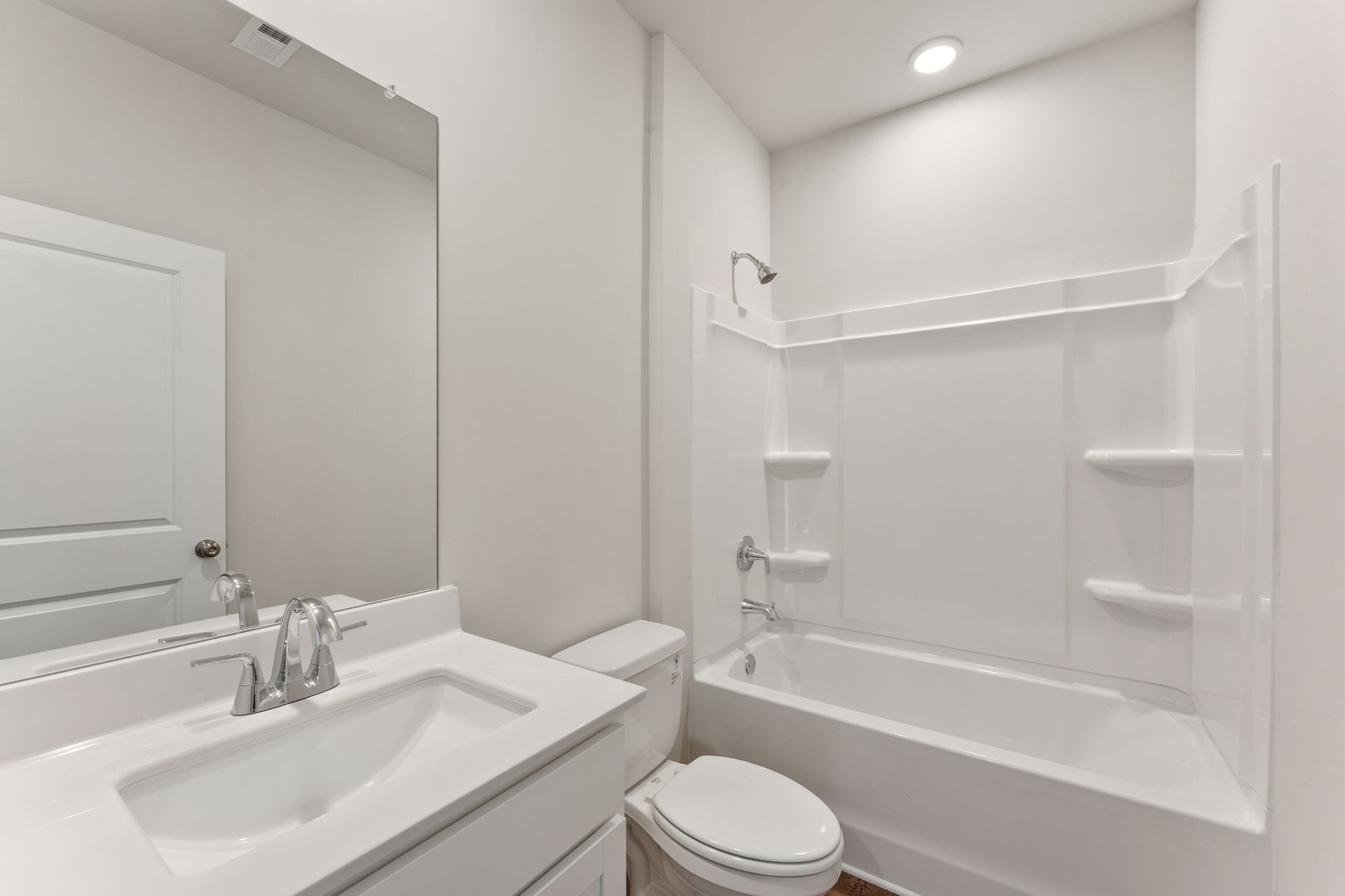 A bathroom with a tub toilet and sink.