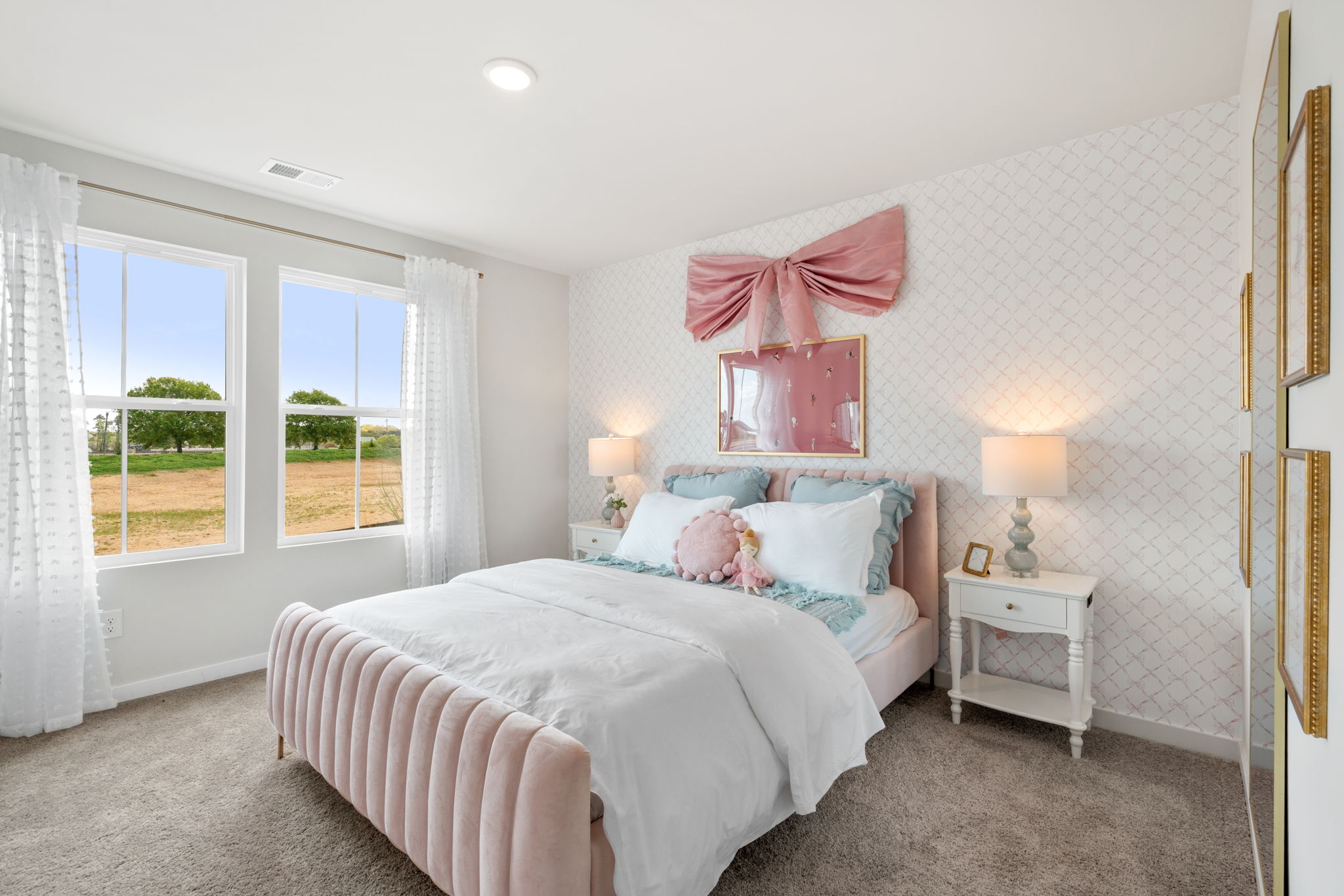 A bedroom with a bed and lamps.