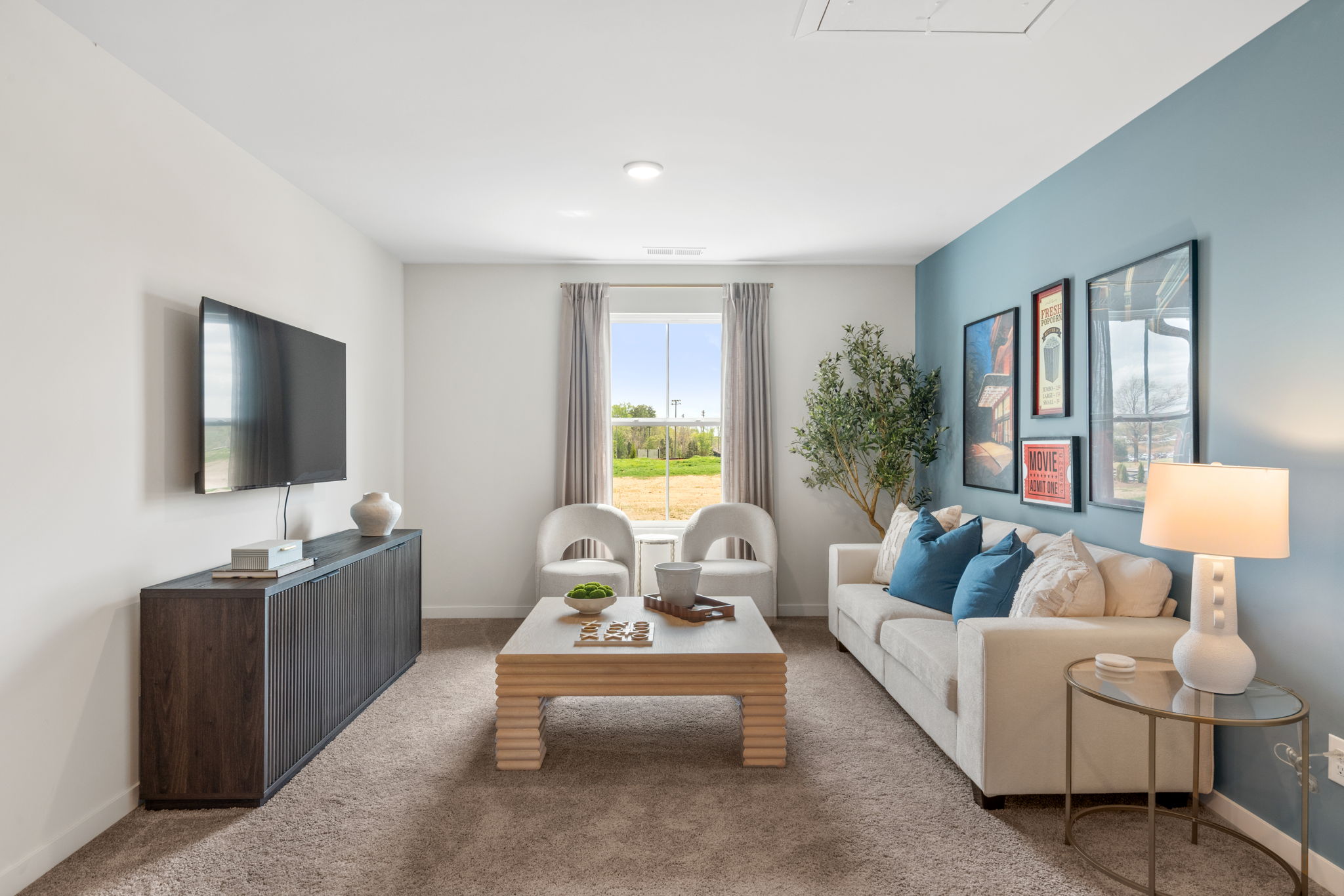 A living room with a white couch and a coffee table.