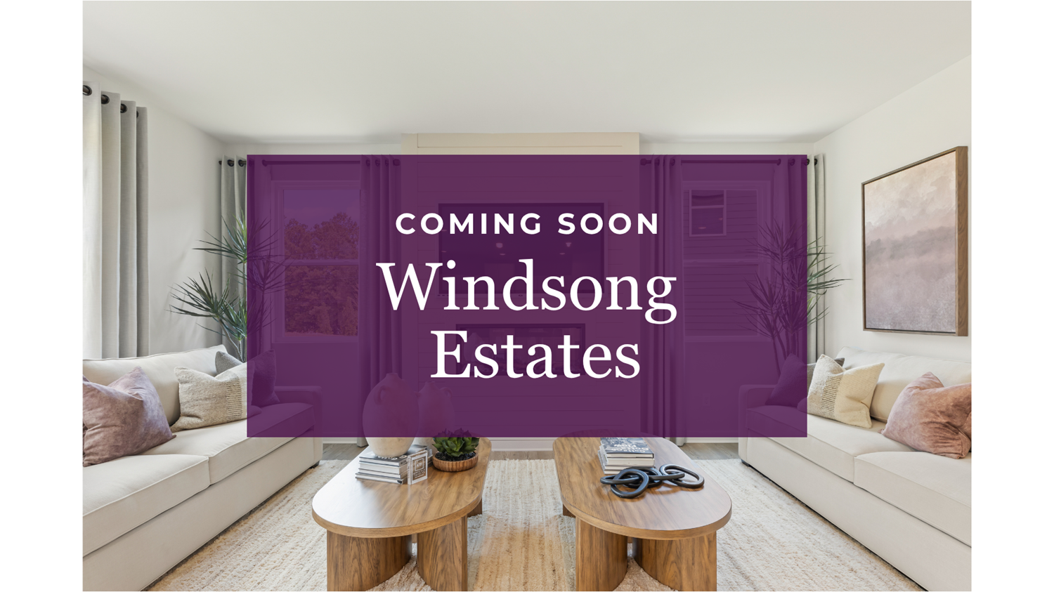 A room with a couch and a table with a sign on it.