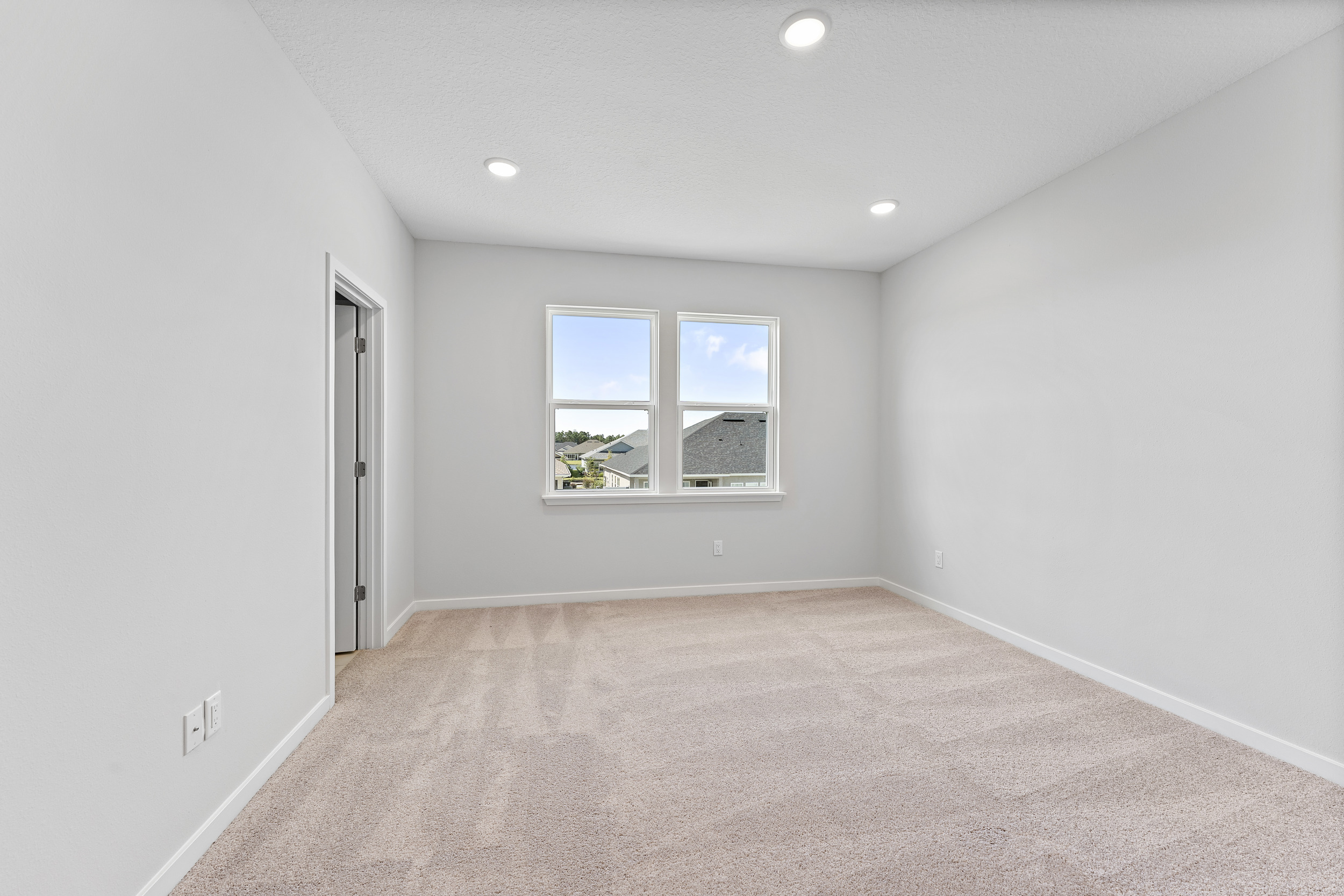 Lot 20 Ponderosa II Primary Bedroom with Large Windows at Camden Woods in Kingsland, GA